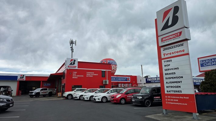 The outdoor sign at Bridgestone Select Dunedin showing their services and contact details